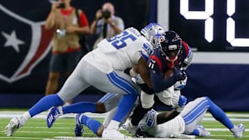 HOUSTON, TEXAS - AUGUST 17: Romeo Okwara #95 of the Detroit Lions forces Steven Mitchell #11 of the Houston Texans to fumble after a reception in the second quarter during a preseason game at NRG Stadium on August 17, 2019 in Houston, Texas. (Photo by Bob Levey/Getty Images)