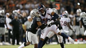 OAKLAND, CALIFORNIA - SEPTEMBER 09: Courtland Sutton #14 of the Denver Broncos is tackled by Gareon Conley #21 and Curtis Riley #35 of the Oakland Raiders during the first quarter at RingCentral Coliseum on September 09, 2019 in Oakland, California. (Photo by Lachlan Cunningham/Getty Images)