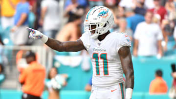 MIAMI, FL - OCTOBER 13: DeVante Parker #11 of the Miami Dolphins points towards the sideline after scoring a touchdown in the fourth quarter against the Washington Redskins at Hard Rock Stadium on October 13, 2019 in Miami, Florida. (Photo by Eric Espada/Getty Images)