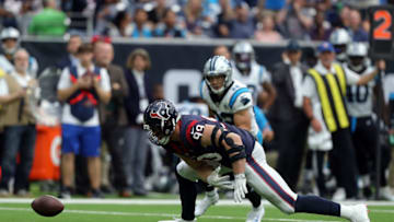 HOUSTON, TEXAS - SEPTEMBER 29: J.J. Watt #99 of the Houston Texans recovers a fumble by Kyle Allen of the Carolina Panthers as Christian McCaffrey #22 looks on during the second half at NRG Stadium on September 29, 2019 in Houston, Texas. (Photo by Bob Levey/Getty Images)