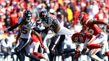 KANSAS CITY, MISSOURI - OCTOBER 13: Running back Carlos Hyde #23 of the Houston Texans carries the ball as strong safety Tyrann Mathieu #32 and cornerback Charvarius Ward #35 of the Kansas City Chiefs defend during the second half of the game at Arrowhead Stadium on October 13, 2019 in Kansas City, Missouri. (Photo by Jamie Squire/Getty Images)