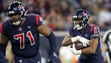 HOUSTON, TX - NOVEMBER 21: Carlos Hyde #23 runs behind the blocking of Tytus Howard #71 of the Houston Texans during the first half of a game against the Indianapolis Colts at NRG Stadium on November 21, 2019 in Houston, Texas. (Photo by Wesley Hitt/Getty Images)