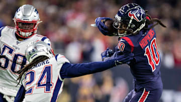 HOUSTON, TX - DECEMBER 1: DeAndre Hopkins #10 of the Houston Texans catches a pass in the second half and tries to avoid the tackle of Stephon Gilmore #24 of the New England Patriots at NRG Stadium on December 1, 2019 in Houston, Texas. The Texans defeated the Patriots 28-22. (Photo by Wesley Hitt/Getty Images)