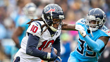 NASHVILLE, TN - DECEMBER 15: DeAnde Hopkins #10 of the Houston Texans runs the ball in the second half and is chased by Tramaine Brock Sr. #35 of the Tennessee Titans at Nissan Stadium on December 15, 2019 in Nashville, Tennessee. The Texans defeated the Titans 24-21. (Photo by Wesley Hitt/Getty Images)