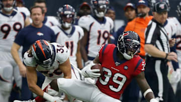 HOUSTON, TEXAS - DECEMBER 08: Tashaun Gipson #39 of the Houston Texans is tackled by Phillip Lindsay #30 of the Denver Broncos after an interception during the third quarter at NRG Stadium on December 08, 2019 in Houston, Texas. (Photo by Bob Levey/Getty Images)