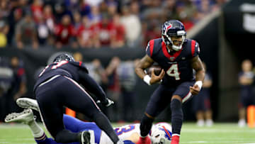 HOUSTON, TEXAS - JANUARY 04: Quarterback Deshaun Watson #4 of the Houston Texans carries the ball over Trent Murphy #93 of the Buffalo Bills in the second quarter of the AFC Wild Card Playoff game at NRG Stadium on January 04, 2020 in Houston, Texas. (Photo by Christian Petersen/Getty Images)