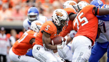 STILLWATER, OK - SEPTEMBER 15: Running back Justice Hill #5 of the Oklahoma State Cowboys looks for a way out of the backfield against the Boise State Broncos at Boone Pickens Stadium on September 15, 2018 in Stillwater, Oklahoma. The Cowboys defeated the Broncos 44-21. (Photo by Brett Deering/Getty Images)