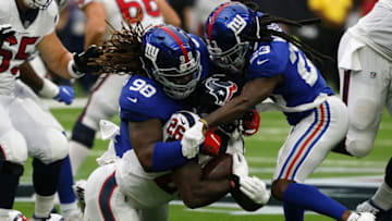 HOUSTON, TX - SEPTEMBER 23: Lamar Miller #26 of the Houston Texans runs the ball, tackled by Damon Harrison #98 and B.W. Webb #23 of the New York Giants in the first quarter at NRG Stadium on September 23, 2018 in Houston, Texas. (Photo by Bob Levey/Getty Images)