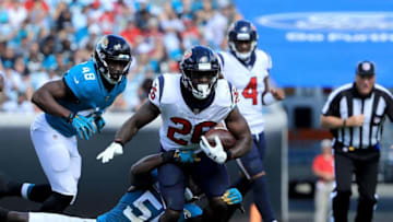 JACKSONVILLE, FL - OCTOBER 21: Telvin Smith #50 of the Jacksonville Jaguars attempts to tackle Lamar Miller #26 of the Houston Texans during the game at TIAA Bank Field on October 21, 2018 in Jacksonville, Florida. (Photo by Sam Greenwood/Getty Images)