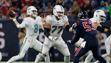 HOUSTON, TX - OCTOBER 25: Brock Osweiler #8 of the Miami Dolphins looks to pass as Jesse Davis #77 blocks Duke Ejiofor #53 of the Houston Texans in the second quarter at NRG Stadium on October 25, 2018 in Houston, Texas. (Photo by Tim Warner/Getty Images)