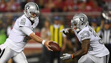 SANTA CLARA, CA - NOVEMBER 01: AJ McCarron #2 of the Oakland Raiders hands the ball off to DeAndre Washington #33 during their NFL game against the San Francisco 49ers at Levi's Stadium on November 1, 2018 in Santa Clara, California. (Photo by Thearon W. Henderson/Getty Images)