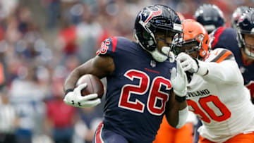 HOUSTON, TX - DECEMBER 02: Lamar Miller #26 of the Houston Texans rushes the ball defended by Emmanuel Ogbah #90 of the Cleveland Browns in the first quarter at NRG Stadium on December 2, 2018 in Houston, Texas. (Photo by Tim Warner/Getty Images)
