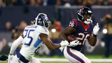 HOUSTON, TEXAS - NOVEMBER 26: Lamar Miller #26 of the Houston Texans rushes past Adoree' Jackson #25 of the Tennessee Titans during the first quarter at NRG Stadium on November 26, 2018 in Houston, Texas. (Photo by Bob Levey/Getty Images)