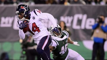 EAST RUTHERFORD, NJ - DECEMBER 15: Wide receiver DeAndre Carter #14 of the Houston Texans is tackled by running back Trenton Cannon #40 of the New York Jets during the third quarter at MetLife Stadium on December 15, 2018 in East Rutherford, New Jersey. (Photo by Steven Ryan/Getty Images)
