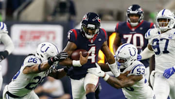 HOUSTON, TX - JANUARY 05: Deshaun Watson #4 of the Houston Texans splits the the tackle attempt by Darius Leonard #53 of the Indianapolis Colts and Clayton Geathers #26 during the Wild Card Round at NRG Stadium on January 5, 2019 in Houston, Texas. (Photo by Bob Levey/Getty Images)