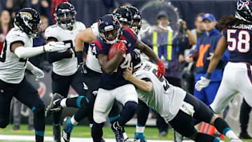 HOUSTON, TEXAS - DECEMBER 30: DeAndre Carter #14 of the Houston Texans breaks the tackle attempt by Logan Cooke #9 of the Jacksonville Jaguars as he returns a punt during the fourth quarter at NRG Stadium on December 30, 2018 in Houston, Texas. (Photo by Bob Levey/Getty Images)