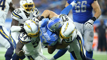 DETROIT, MI - SEPTEMBER 15: Kerryon Johnson #33 of the Detroit Lions runs the ball and is tackled by Joey Bosa #97 and Melvin Ingram #54 of the Los Angeles Chargers in the third quarter at Ford Field on September 15, 2019 in Detroit, Michigan. (Photo by Rey Del Rio/Getty Images)
