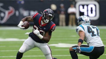 HOUSTON, TEXAS - SEPTEMBER 29: Carlos Hyde #23 of the Houston Texans attempts to run around Ross Cockrell #47 of the Carolina Panthers during the first half at at NRG Stadium on September 29, 2019 in Houston, Texas. (Photo by Bob Levey/Getty Images)
