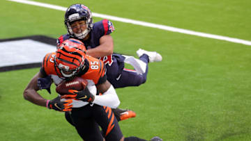 HOUSTON, TEXAS - DECEMBER 27: Wide receiver Tee Higgins #85 of the Cincinnati Bengals completes a pass for a touchdown over cornerback John Reid #34 of the Houston Texans during the third quarter of the game at NRG Stadium on December 27, 2020 in Houston, Texas. (Photo by Carmen Mandato/Getty Images)