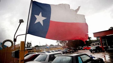 HOUSTON, TX - AUGUST 26: Wind from Hurricane Harvey batters a Texas flag on August 26, 2017 in Houston, Texas. Harvey, which made landfall north of Corpus Christi late last night, is expected to dump upwards to 40 inches of rain in Texas over the next couple of days. (Photo by Scott Olson/Getty Images)
