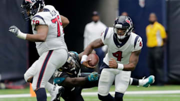 HOUSTON, TX - SEPTEMBER 10: Deshaun Watson #4 of the Houston Texans scrambles out of the grasp from Malik Jackson #97 of the Jacksonville Jaguars in the third quarter at NRG Stadium on September 10, 2017 in Houston, Texas. (Photo by Tim Warner/Getty Images)