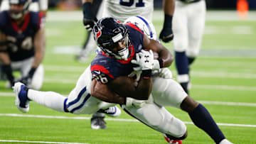 HOUSTON, TEXAS - JANUARY 05: Lamar Miller #26 of the Houston Texans is tackled by Clayton Geathers #26 of the Indianapolis Colts during the Wild Card Round at NRG Stadium on January 05, 2019 in Houston, Texas. (Photo by Bob Levey/Getty Images)
