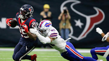 HOUSTON, TEXAS - JANUARY 04: Duke Johnson #25 of the Houston Texans is tackled by Jordan Poyer #21 of the Buffalo Bills during the AFC Wild Card Playoff game at NRG Stadium on January 04, 2020 in Houston, Houston won 22-19 in overtime. (Photo by Bob Levey/Getty Images)