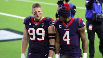HOUSTON, TEXAS - JANUARY 03: J.J. Watt #99 of the Houston Texans walks off the field with Deshaun Watson #4 following a game against the Tennessee Titans at NRG Stadium on January 03, 2021 in Houston, Texas. (Photo by Carmen Mandato/Getty Images)