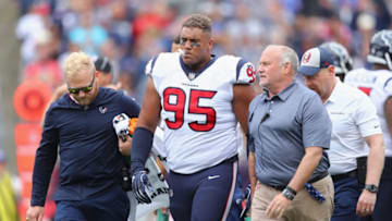 FOXBOROUGH, MA - SEPTEMBER 09: Christian Covington #95 of the Houston Texans is helped off the field by training staff during the first half against the New England Patriots at Gillette Stadium on September 9, 2018 in Foxborough, Massachusetts. (Photo by Maddie Meyer/Getty Images)