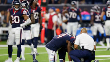 HOUSTON, TX - OCTOBER 07: Deshaun Watson #4 of the Houston Texans is tended to by training staff in the fourth quarter against the Dallas Cowboys at NRG Stadium on October 7, 2018 in Houston, Texas. (Photo by Tim Warner/Getty Images)
