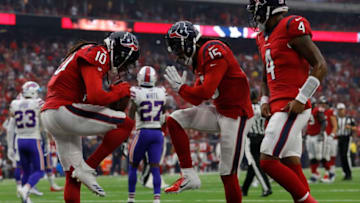 HOUSTON, TX - OCTOBER 14: DeAndre Hopkins #10, Will Fuller #15 and Deshaun Watson #4 of the Houston Texans celebrate a touchdown reception against the Buffalo Bills in the first quarter at NRG Stadium on October 14, 2018 in Houston, Texas. (Photo by Tim Warner/Getty Images)