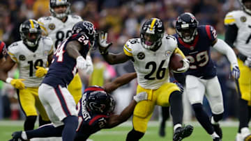 HOUSTON, TX - DECEMBER 25: Le'Veon Bell #26 of the Pittsburgh Steelers gives a stiff arm to Johnathan Joseph #24 of the Houston Texans in the first quarter at NRG Stadium on December 25, 2017 in Houston, Texas. (Photo by Tim Warner/Getty Images)