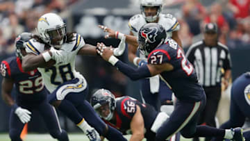 HOUSTON, TX - NOVEMBER 27: Melvin Gordon #28 of the San Diego Chargers gives a stiff arm to Quintin Demps #27 of the Houston Texans in the second quarter at NRG Stadium on November 27, 2016 in Houston, Texas. (Photo by Tim Warner/Getty Images)