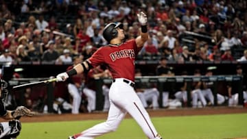 Jun 12, 2016; Phoenix, AZ, USA; Arizona Diamondbacks right fielder David Peralta (6) hits a sacrifice fly allowing second baseman Jean Segura (2) to score in the first inning against the Miami Marlins at Chase Field. Mandatory Credit: Matt Kartozian-USA TODAY Sports