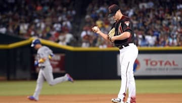 Sep 17, 2016; Phoenix, AZ, USA; Arizona Diamondbacks starting pitcher Shelby Miller (26) reacts after giving up a two run to Los Angeles Dodgers center fielder Joc Pederson (31) during the third inning at Chase Field. Mandatory Credit: Joe Camporeale-USA TODAY Sports
