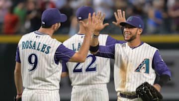 PHOENIX, AZ - SEPTEMBER 14: Adam Rosales #9, Jake Lamb #22 and Gregor Blanco #5 of the Arizona Diamondbacks celebrate after closing out the MLB game against the Colorado Rockies at Chase Field on September 14, 2017 in Phoenix, Arizona. (Photo by Jennifer Stewart/Getty Images)