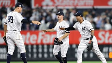 NEW YORK, NY - OCTOBER 03: Aaron Judge #99 of the New York Yankees celebrates with Aaron Hicks #31 and Brett Gardner #11 after defeating the Minnesota Twins in the American League Wild Card Game at Yankee Stadium on October 3, 2017 in the Bronx borough of New York City. The New York Yankees defeated the Minnesota Twins with a score of 4 to 8. (Photo by Elsa/Getty Images)