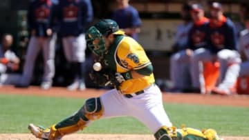 Aug 9, 2015; Oakland, CA, USA; Oakland Athletics catcher Josh Phegley (19) is unable to control the ball as it bounces off his chest before a Houston Astros run during the sixth inning at O.co Coliseum. Mandatory Credit: Kelley L Cox-USA TODAY Sports