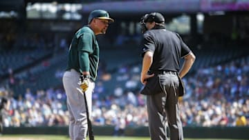 Aug 26, 2015; Seattle, WA, USA; Oakland Athletics designated hitter Billy Butler (16) speaks with home plate umpire Paul Schrieber (43) during a second inning at bat against the Seattle Mariners at Safeco Field. Mandatory Credit: Joe Nicholson-USA TODAY Sports
