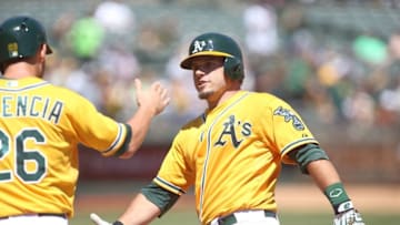 Sep 2, 2015; Oakland, CA, USA; Oakland Athletics catcher Josh Phegley (19) high fives third baseman Danny Valencia (26) after batting him in on a two run home run against the Los Angeles Angels during the first inning at O.co Coliseum. Mandatory Credit: Kelley L Cox-USA TODAY Sports