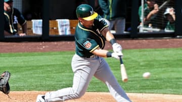 Mar 15, 2016; Salt River Pima-Maricopa, AZ, USA; Oakland Athletics left fielder Jake Smolinski (5) singles in the fourth inning against the Colorado Rockies at Salt River Fields at Talking Stick. Mandatory Credit: Matt Kartozian-USA TODAY Sports