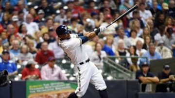 Sep 15, 2015; Milwaukee, WI, USA; Milwaukee Brewers left fielder Khris Davis (18) hits a solo home run in the fifth inning against the St. Louis Cardinals at Miller Park. Mandatory Credit: Benny Sieu-USA TODAY Sports
