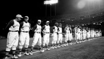 From Swining A’s Jan 2015 post “Life With Reggie’s Regiment, The Mustache Gang & Billy Ball”The Oakland Athletics line up along the third baseline before their first home game at the Oakland-Alameda County Coliseum in Oakland, April 17, 1968. 50,164 fans along with Hall of Famer A’s coach Joe DiMaggio (far left) were in attendance as the A's lost to the Baltimore Orioles 4-1. (photo permission by Ron Riesterer/Oakland Tribune