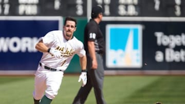Apr 17, 2016; Oakland, CA, USA; Oakland Athletics center fielder Billy Burns (1) loses his helmet as he runs for third base on a triple against the Kansas City Royals during the eighth inning at the Oakland Coliseum. The Athletics won 3-2. Mandatory Credit: Kelley L Cox-USA TODAY Sports