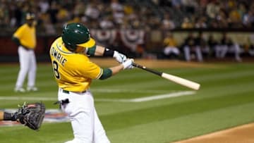 Apr 5, 2016; Oakland, CA, USA; Oakland Athletics second baseman Jed Lowrie (8) hits an RBI single against the Chicago White Sox during the third inning at the Oakland Coliseum. Mandatory Credit: Kelley L Cox-USA TODAY Sports