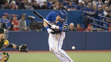 Apr 23, 2016; Toronto, Ontario, CAN; Toronto Blue Jays third baseman Josh Donaldson (20) gets hit with a pitch during the sixth inning in a game against the Oakland Athletics at Rogers Centre. Mandatory Credit: Nick Turchiaro-USA TODAY Sports