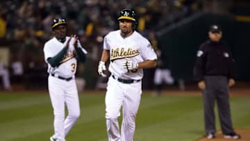Apr 12, 2016; Oakland, CA, USA; Oakland Athletics shortstop Marcus Semien (10) celebrates with third base coach Ron Washington (38) on a solo home run against the Los Angeles Angels during the third inning at the Oakland Coliseum. Mandatory Credit: Kelley L Cox-USA TODAY Sports