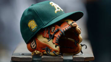 DENVER, CO - JULY 29: An Oakland Athletics player's hat and glove rests in the dugout during interleague play between the Colorado Rockies and the Oakland Athletics at Coors Field on July 29, 2018 in Denver, Colorado. (Photo by Dustin Bradford/Getty Images)