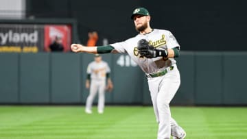 BALTIMORE, MD - SEPTEMBER 13: Jed Lowrie #8 of the Oakland Athletics throws the ball to first base against the Baltimore Orioles at Oriole Park at Camden Yards on September 13, 2018 in Baltimore, Maryland. (Photo by G Fiume/Getty Images)