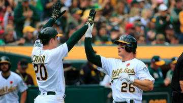 OAKLAND, CALIFORNIA - MAY 27: Matt Chapman #26 celebrates with Mark Canha #20 of the Oakland Athletics after scoring during the fifth inning against the Los Angeles Angels at Oakland-Alameda County Coliseum on May 27, 2019 in Oakland, California. (Photo by Daniel Shirey/Getty Images)